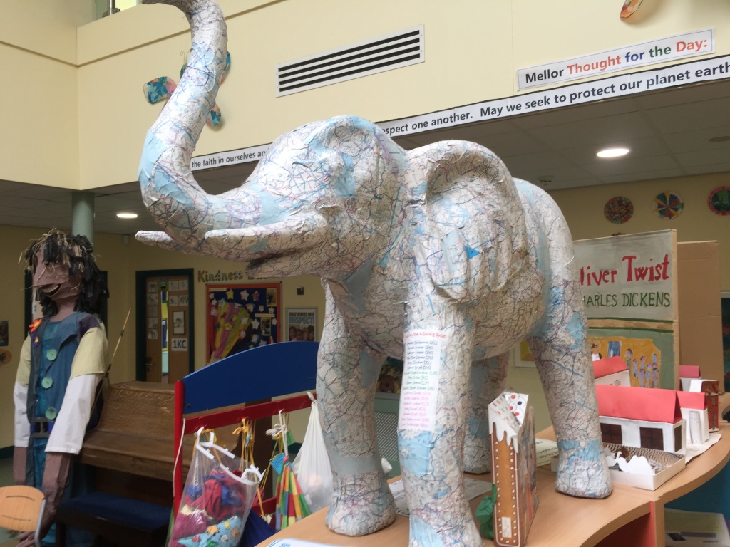 Bel Giant figure and map covered elephant