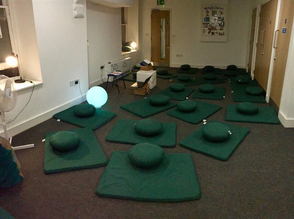 Mindfulness room - green with cushions on the floor and soft lighting